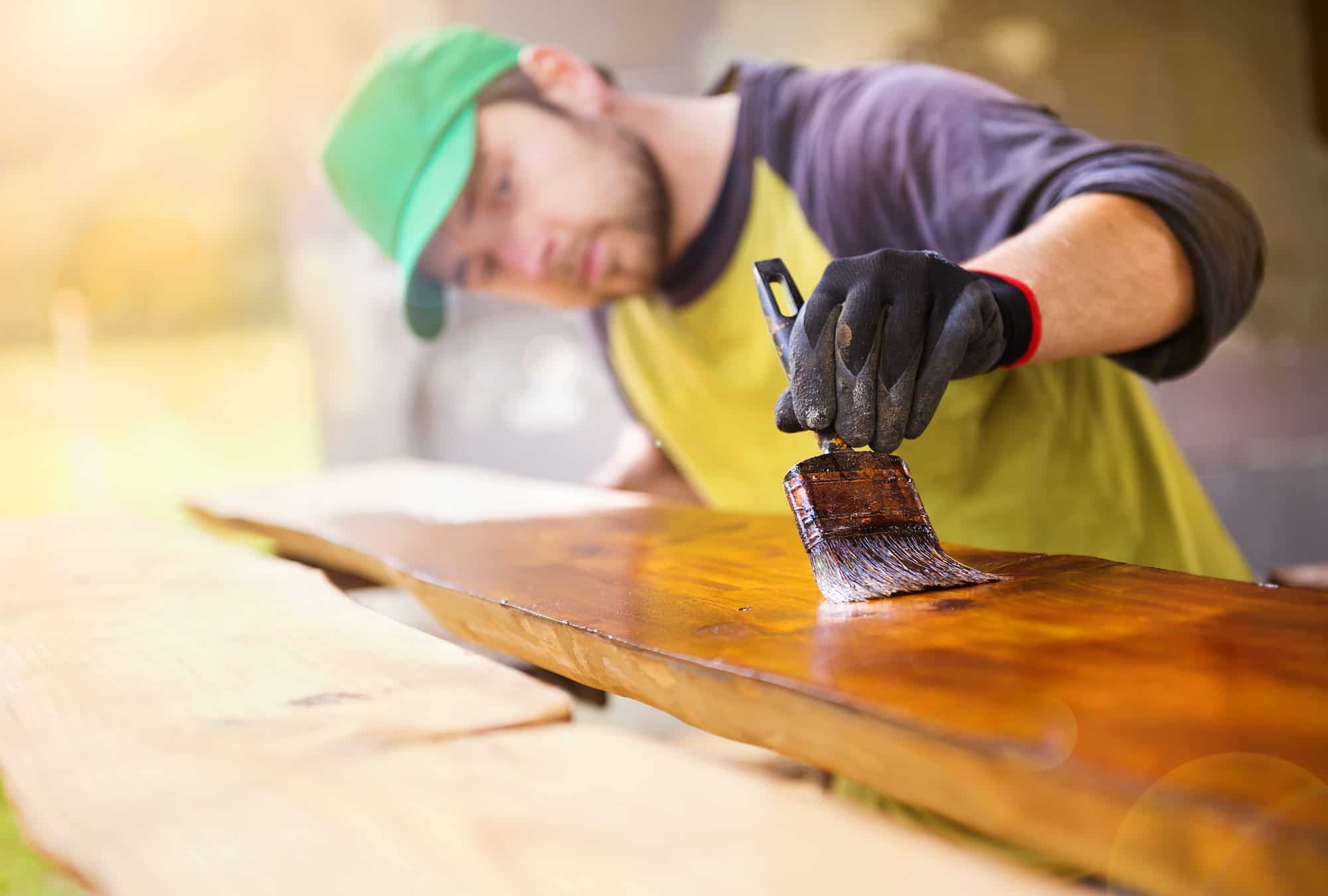 handyman-varnishing-wooden-planks-outside.jpg
